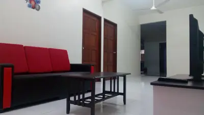 a living room with a couch and a table at Taiping Vacation Homestay in Taiping
