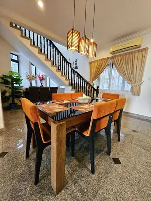 a dining room with a wooden table and chairs at Little Heaven by Sky Hive, A Beach Front Bungalow in Tanjung Bungah