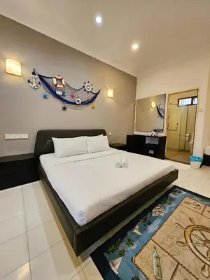 a bedroom with a large bed in a room at Little Heaven by Sky Hive, A Beach Front Bungalow in Tanjung Bungah
