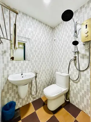 a bathroom with a toilet and a sink at Hotel Sagittario in Ipoh