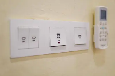 a wall with switches and a remote control on a wall at Dream & Wander Homestay in Ipoh