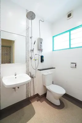 a white bathroom with a toilet and a sink at Dream & Wander Homestay in Ipoh