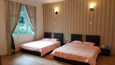a bedroom with two beds and a window at Shamrock Villas Corner OR Seaview OR Standard in Batu Ferringhi