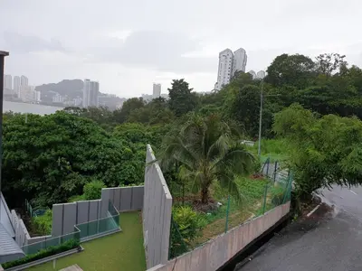 a view of a park with a fence and trees at Shamrock Villas Corner OR Seaview OR Standard in Batu Ferringhi