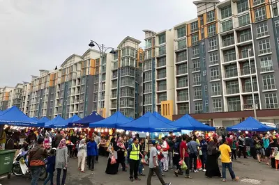 a large crowd of people standing in front of large buildings at Dephane Apartment in Cameron Highlands