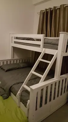 a white bunk bed with a ladder on it at Dephane Apartment in Cameron Highlands