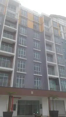 a large apartment building with a lot of windows at Dephane Apartment in Cameron Highlands