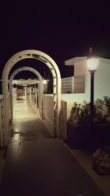 a street light next to a building at night at Dephane Apartment in Cameron Highlands