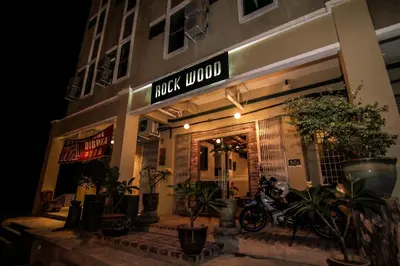 a moped parked outside of a music lounge at night at Rock Wood Hotel in Sungai Petani