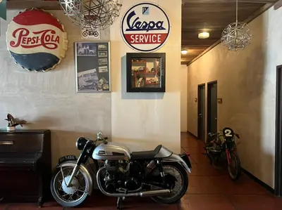 a motorcycle parked in a room with signs on the wall at Rock Wood Hotel in Sungai Petani