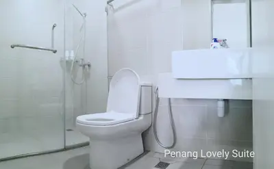 a bathroom with a toilet and a shower and a sink at Penang Studio Suite in Georgetown in George Town