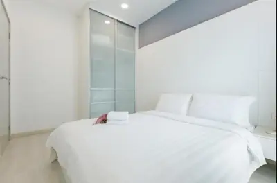 a white bedroom with a large white bed at Penang Studio Suite in Georgetown in George Town