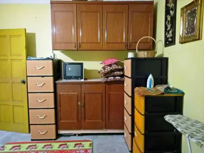 a kitchen with a desk with a laptop computer on it at Farzai Homestay in Lumut