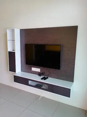 a flat screen tv on a wall at Cameron's Square Apartment in Cameron Highlands