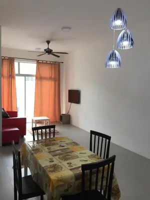 a dining room with a table and chairs and a ceiling fan at Cameron's Square Apartment in Cameron Highlands