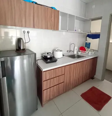 a small kitchen with a sink and a refrigerator at Cameron's Square Apartment in Cameron Highlands