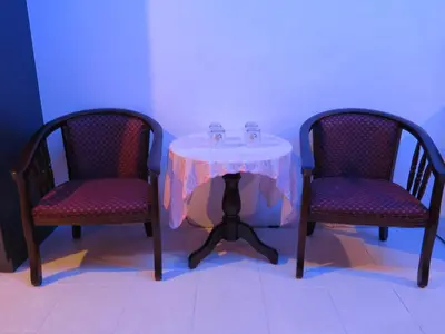 a table with two chairs and a table with two glasses on it at Pangkor Lot 10 Vacation Studio in Pangkor