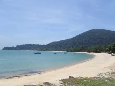 a beach with a bunch of boats in the water at Pangkor Lot 10 Vacation Studio in Pangkor