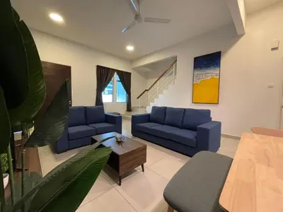 a living room with blue couches and a table at DreamScape Apartment @ Golden Hill in Cameron Highlands