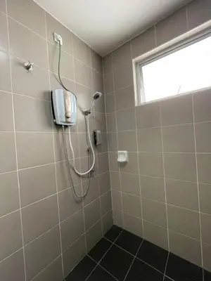 a shower in a bathroom with a phone on the wall at DreamScape Apartment @ Golden Hill in Cameron Highlands