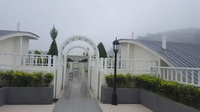 a hallway of a house with an arch and a street light at Feel Homestay in Cameron Highlands