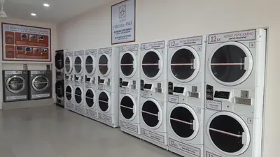 a row of washing machines in a laundry room at Feel Homestay in Cameron Highlands