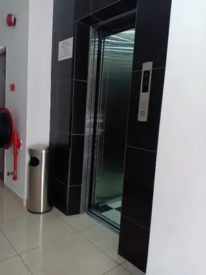 a shower with a glass door in a bathroom at Hotel Alpha in Bukit Mertajam