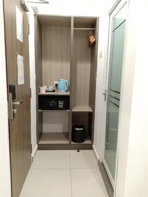 a walk in pantry with a glass door at Hotel Alpha in Bukit Mertajam