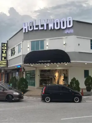 a black minivan parked in front of a hotel at Hollywood Hotel in Ipoh