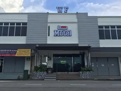 a motel with a sign on top of a building at WF Motel in Kulim