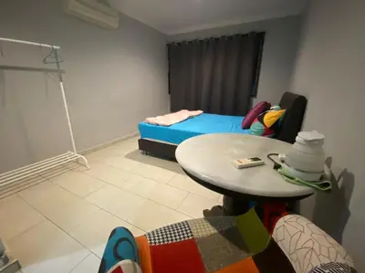 a small room with a table and a bed at YY Residences in Ipoh