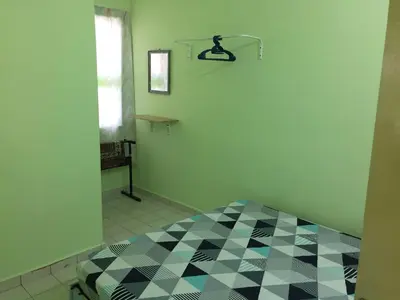 a room with a bed with a checkered floor at Kak's House Musl!m Only in Ipoh