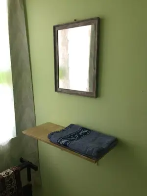 a room with a shelf and a mirror on the wall at Kak's House Musl!m Only in Ipoh