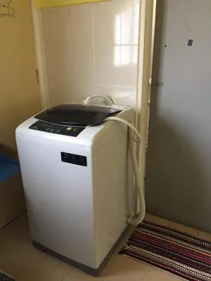 a small white refrigerator sitting in a room at Kak's House Musl!m Only in Ipoh