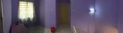 a hallway with purple walls and a door with a window at Kak's House Musl!m Only in Ipoh