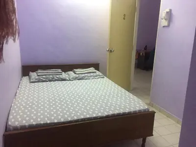 a small bed in a room with purple walls at Kak's House Musl!m Only in Ipoh