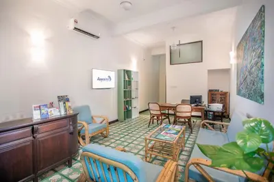 a living room with chairs and a table at Areca Hotel Penang in George Town