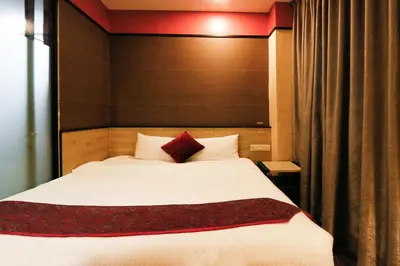 a bedroom with a large white bed in a room at Golden Roof Hotel, Seri Iskandar in Seri Iskandar