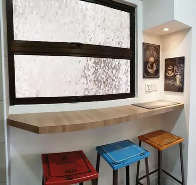 a window in a room with stools under it at Sri Sayang by Coral Holiday Resort in Batu Ferringhi
