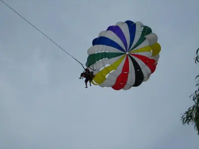 a person is hanging from a parachute at Sri Sayang by Coral Holiday Resort in Batu Ferringhi