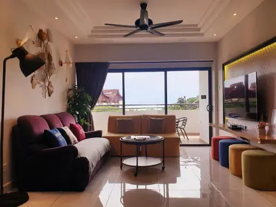 a living room with a couch and a ceiling fan at Sri Sayang by Coral Holiday Resort in Batu Ferringhi