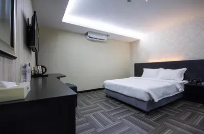a hotel room with a bed and a television at S Hotel Seberang Jaya in Perai
