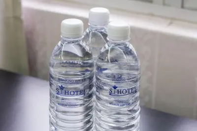 two bottles of water sitting on top of a table at S Hotel Seberang Jaya in Perai