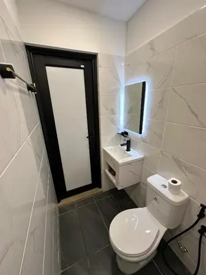 a bathroom with a toilet and a sink and a mirror at S Hotel Seberang Jaya in Perai