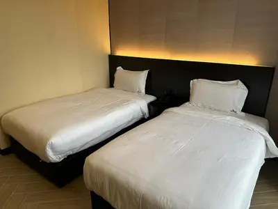 two beds sitting next to each other in a room at S Hotel Seberang Jaya in Perai