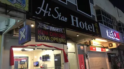 a store with signs on the side of a building at Hi Star Hotel in Sitiawan