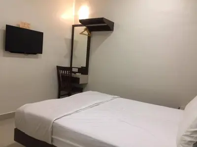 a bedroom with a bed and a flat screen tv at Hi Star Hotel in Sitiawan