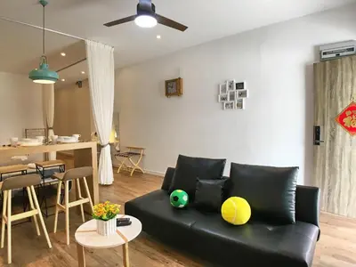 a living room with a black couch and a table at iBook Gurney Suites in George Town
