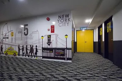 a hallway with a new york city mural on the wall at Manhattan Hotel Ipoh in Ipoh