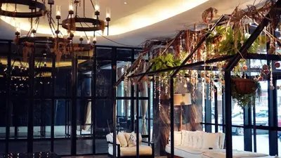 a room with a large window and a chandelier at M Roof Hotel & Residences in Ipoh